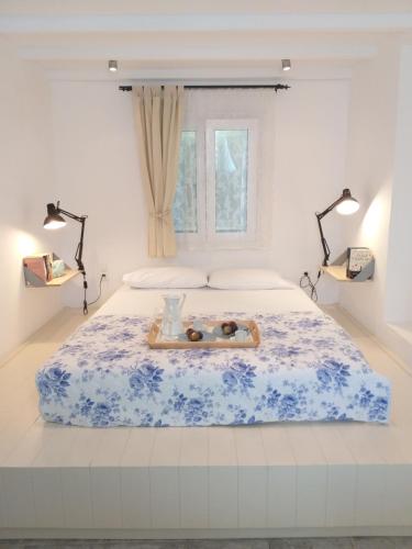 a bedroom with a bed with a tray of donuts on it at Mike'sPlace in Antiparos Town