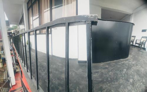 a metal railing in front of a building at Night manner hostel in Ella