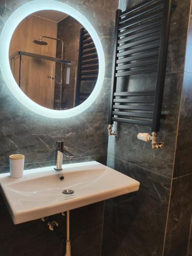 a bathroom with a sink and a mirror at APART 558 Szczyrk, Ski&Bike, basen, blisko wyciągów i szlaków in Szczyrk