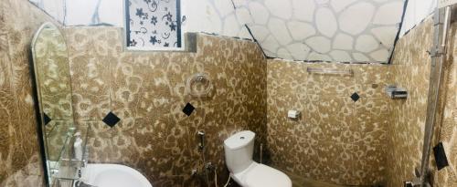 a bathroom with a toilet and a glass shower at Night manner hostel in Ella