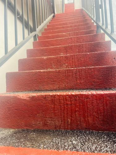 a set of red stairs in a building at Night manner hostel in Ella