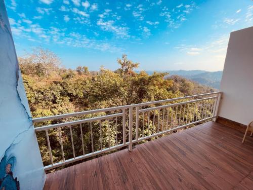 a balcony with a view of the mountains at Paradise Woodland Resort Chintpurni in Bharwain