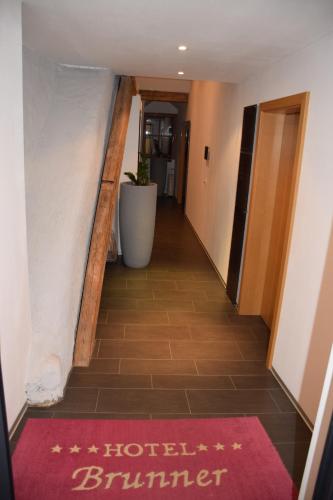 a hallway with a red rug on the floor at Appartement-Hotel GH Zum Goldenen Schiff in Enns