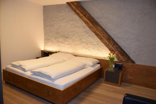 a bedroom with a bed with a large window at Hotel zum Goldenen Schiff in Enns