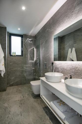 a bathroom with two sinks and a shower at Pentacle Villas in Lefkada Town