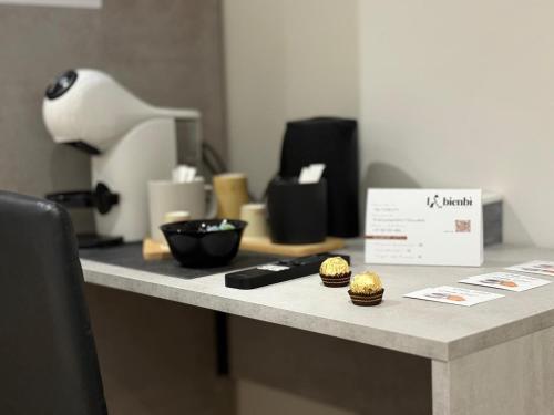 a counter with a table with cupcakes on it at LaBienbi' in Cosenza