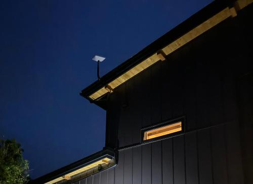 a building with a light on the side of it at 富津オフグリッドハウス - Futtsu Seaside Off-Grid House with Private Sauna in Futtsu