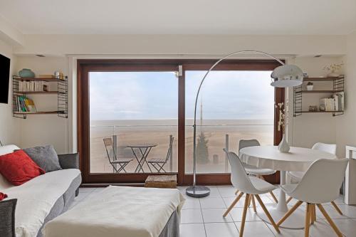 a living room with a view of the ocean at Atlantis 0102 in Sint-Idesbald