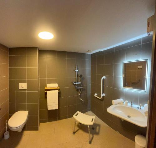 a bathroom with a toilet and a sink at au petit quinquin in Céaux