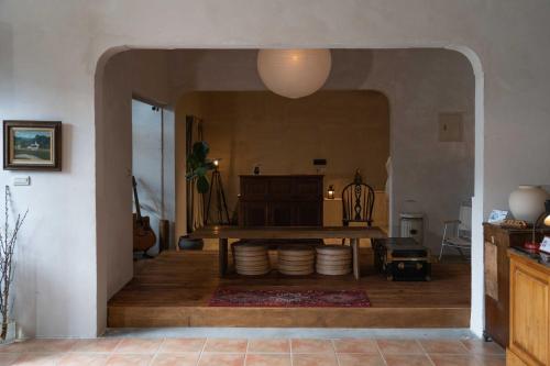 a kitchen with a table and a room with a floor at The Peaceful Village 花蓮小和民宿 2090&1 in Pinghe