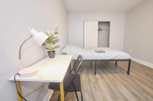 a room with a bed and a table with a lamp at Blue Stay near BMO Stadium and USC Private Room in Los Angeles