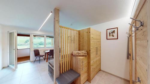 a room with a wooden partition with a table in it at Ferienwohnungen Hinterholzer in Sankt Jakob in Haus