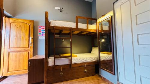 a room with two bunk beds and a door at JACK'S DEN residency in Puducherry