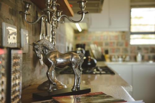 a bronze horse statue on a counter in a kitchen at Secure, luxurious with lovely views in Pringle Bay