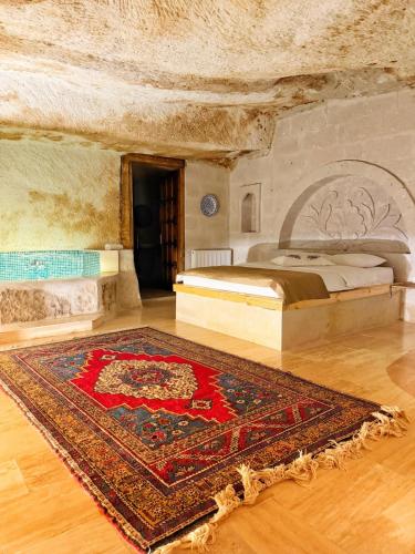 a bedroom with a bed and a rug on the floor at My Cave Suites in Nevsehir