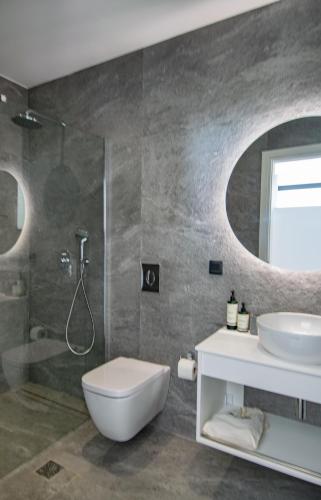 a bathroom with a toilet and a sink and a shower at Pentacle Villas in Lefkada Town