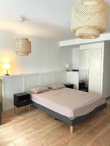 - une chambre avec un lit, deux lampes et un miroir dans l'établissement Loft spa, cour arrière privée, à Labruguière