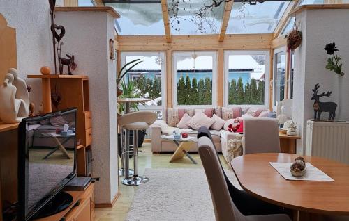 a living room with a couch and a table at Ferienhaus Mit Sauna in Fohnsdorf