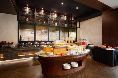 a restaurant with a table with food on it at Ramada Encore Jalandhar in Jalandhar