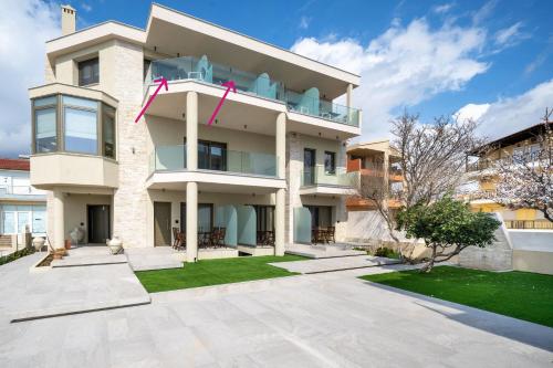 a large white building with a yard at Reverie in Limenaria