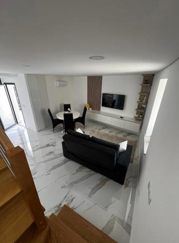 a living room with a couch and a table at Maison de village in Dornelas