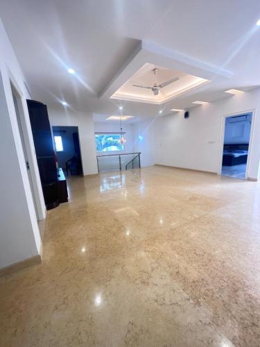 an empty room with a table in the middle at Luxury Villa in Heart of the city in Haidar Sāhibgūda