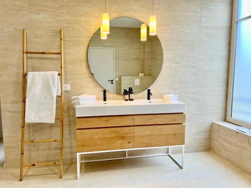 a bathroom with a sink and a mirror at Villa Marie et Martin in Dijon