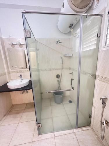 a bathroom with a shower and a toilet and a sink at Luxury Villa in Heart of the city in Haidar Sāhibgūda