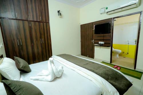 a bedroom with a bed with a stuffed animal on it at Moon Land Hotel in Jaipur