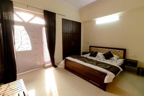 a bedroom with a bed and a large window at Moon Land Hotel in Jaipur