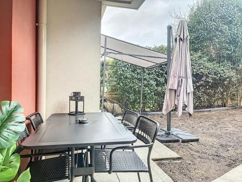 - une table, des chaises et un parasol sur la terrasse dans l'établissement 2 Bedrooms, near Paris, family friendly, metro RER, à Rosny-sous-Bois