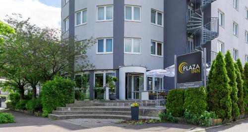 a building with a staircase in front of it at PLAZA INN Stuttgart Airport Messe in Filderstadt