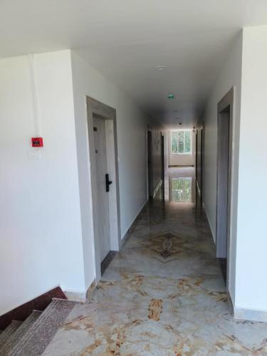 an empty hallway of an empty house with a tile floor at Hotel Akshaya in Port Blair