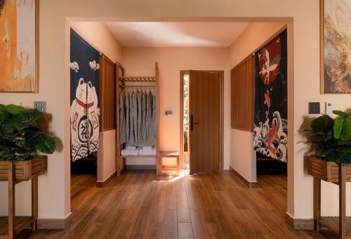a hallway with wooden floors and paintings on the walls at Olala Glamping Bảo Lộc in Bao Loc