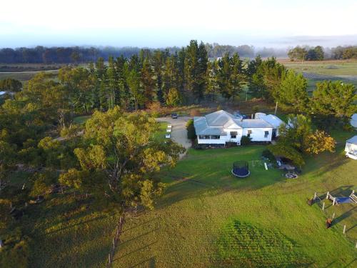 an aerial view of a large white house on a field at Seagoe Homestead in Stanthorpe
