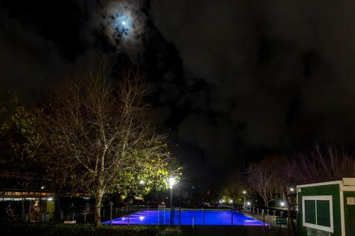 a tennis court at night with the moon in the sky at hu Roma Camping In Town in Rome