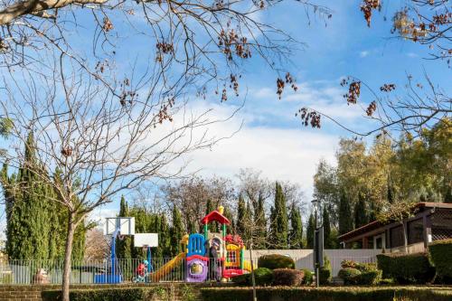 a playground in a park with a colorful playground at hu Roma Camping In Town in Rome