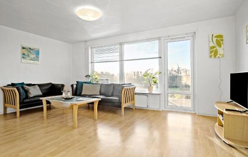 a living room with a couch and a table at 2 Bedroom Nice Home In Roslev in Roslev
