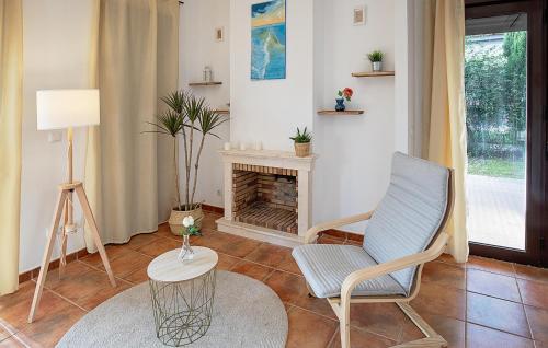 a living room with a chair and a fireplace at Nice Home In Guillena With Wifi in Guillena