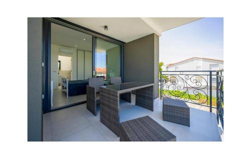 a balcony with a table and a view of a room at 4 Bedroom Stunning Home In Murter in Murter