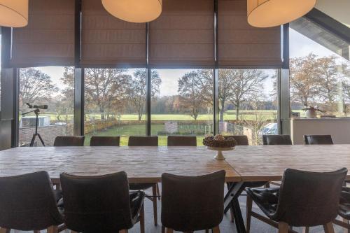 a large dining room with a large table and chairs at De Zwaluwhoeve in Peer