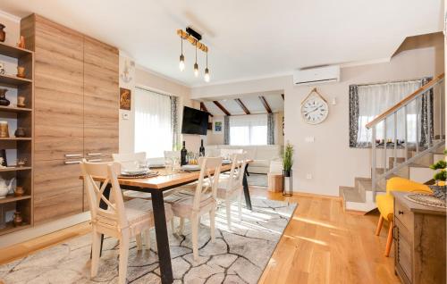 a dining room and living room with a table and chairs at Gorgeous Home In Plesivica With Sauna in Plešivica