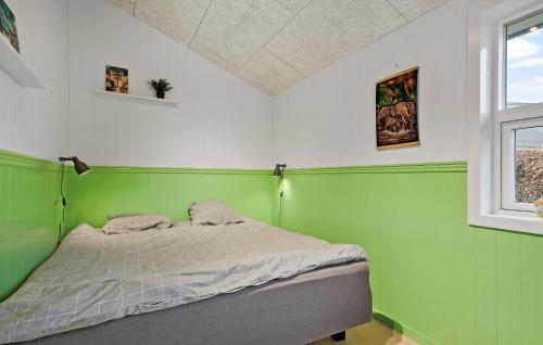 a bedroom with green and white walls and a bed at 3 Bedroom Stunning Home In Frørup in Frørup