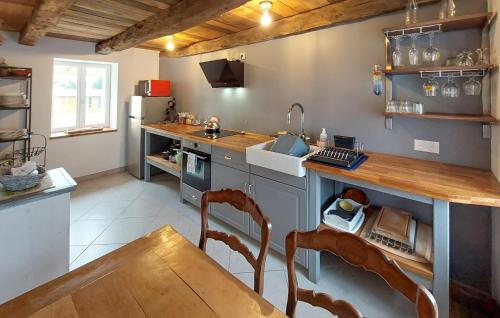 a kitchen with a counter and a sink and a table at 2 Bedroom Cozy Home In Plumieux in Plumieux