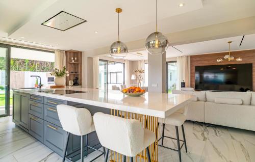 a kitchen with a large island with white counter tops at Amazing Villa With Heated Pool in Benalmádena