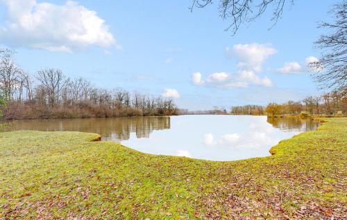 a large pond with a cloudy sky in a field at Stunning Home In Égriselles-Le-Bocage in Égriselles-le-Bocage