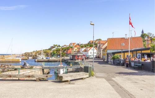 a town with a marina with boats in the water at Gudhjem Søpark Lejl 47 in Gudhjem
