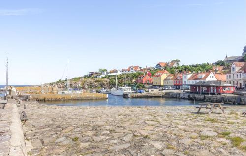 a town with a marina with boats in the water at Gudhjem Søpark Lejl 47 in Gudhjem