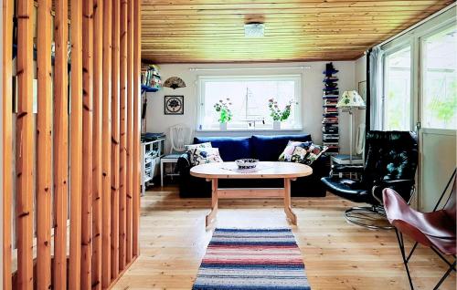 a living room with a table and a couch at 2 Bedroom Awesome Home In Sävsjö in Sävsjö