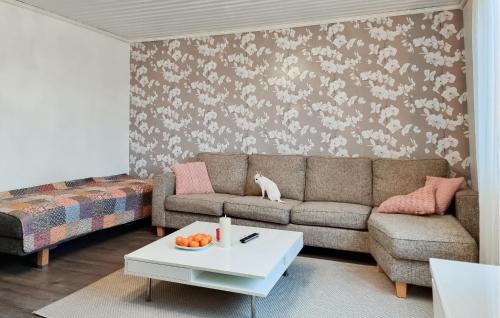 a living room with a couch and a coffee table at 4 Bedroom Pet Friendly Home In Upplid in Upplid